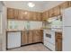 Efficient kitchen with light wood cabinets, and ample counter space with an adjoining pass-through at 1032 Calanda Ave # 1032, Orlando, FL 32807