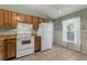 Bright kitchen with light wood cabinets, tile flooring, and modern white appliances at 1032 Calanda Ave # 1032, Orlando, FL 32807