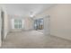 Inviting living room with a ceiling fan, large window, and sliding glass doors leading to the exterior at 1032 Calanda Ave # 1032, Orlando, FL 32807