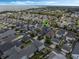 An aerial shot highlighting a home's location in a community, near a body of water and a wooded area at 1034 Huntspoint St, Winter Garden, FL 34787