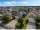 Aerial of a blue two-story home with a garage and manicured lawn in a peaceful, well-maintained neighborhood at 1034 Huntspoint St, Winter Garden, FL 34787