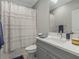 This full bathroom features a shower/tub combo, white shower curtain, and vanity with decorative towels at 1034 Huntspoint St, Winter Garden, FL 34787