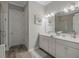 This elegant bathroom features a double vanity and separate door to a glass-enclosed shower at 1034 Huntspoint St, Winter Garden, FL 34787