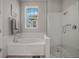 This bathroom features a glass-enclosed shower and a tub with subway tile at 1034 Huntspoint St, Winter Garden, FL 34787