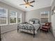 This neutral bedroom is carpeted and features three large windows and an antique-style bed frame at 1034 Huntspoint St, Winter Garden, FL 34787
