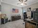 This carpeted bedroom features a ceiling fan, American flag decor, and a stylish storage cabinet at 1034 Huntspoint St, Winter Garden, FL 34787