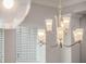 Elegant chandelier with frosted shades, providing a soft and warm ambient light at 1034 Huntspoint St, Winter Garden, FL 34787