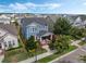 Charming two-story blue home with a welcoming front porch and lush landscaping in a Gathering-friendly neighborhood at 1034 Huntspoint St, Winter Garden, FL 34787