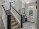 Inviting foyer featuring staircase, light-colored hardwood floors, and a front door with sidelight windows at 1034 Huntspoint St, Winter Garden, FL 34787