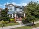 Attractive blue home with a welcoming front porch featuring brick pillars, steps, and manicured landscaping at 1034 Huntspoint St, Winter Garden, FL 34787