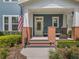 Inviting front porch featuring classic brick columns, comfortable seating, and decorative accents by the front door at 1034 Huntspoint St, Winter Garden, FL 34787