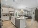 Open kitchen with a central island, stainless steel appliances, hardwood floors, and an open-concept design at 1034 Huntspoint St, Winter Garden, FL 34787