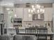 Stylish kitchen with modern stainless steel appliances, white cabinets, and a dining area with a view of the living room at 1034 Huntspoint St, Winter Garden, FL 34787
