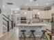Well-lit kitchen featuring a large island with seating, stainless steel appliances, and a tiled backsplash at 1034 Huntspoint St, Winter Garden, FL 34787
