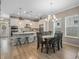Open kitchen and dining area with an island, pendant lights, and stainless steel appliances at 1034 Huntspoint St, Winter Garden, FL 34787