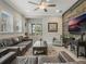 Comfortable living room featuring a leather sofa, wood accent wall, and large windows at 1034 Huntspoint St, Winter Garden, FL 34787