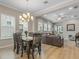 Open-concept living and dining areas with wood floors, a neutral color palette, and plenty of natural light at 1034 Huntspoint St, Winter Garden, FL 34787