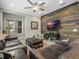 Cozy living room with a decorative wood wall, plush seating, and a large flat-screen television at 1034 Huntspoint St, Winter Garden, FL 34787