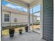 Cozy screened-in porch with decorative planters and views of the manicured backyard and neighboring homes at 1034 Huntspoint St, Winter Garden, FL 34787