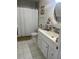 Bright bathroom with white vanity, marble floors, and a shower with tiled walls and glass door at 1034 Villa Ln # 18, Apopka, FL 32712