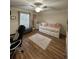 Comfortable bedroom with wood floors, a daybed, a black leather desk chair, and ample natural light at 1034 Villa Ln # 18, Apopka, FL 32712