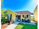 Charming single-story home with a cozy front porch, lush landscaping, and inviting curb appeal at 1034 Villa Ln # 18, Apopka, FL 32712