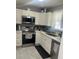 Efficient kitchen with white cabinets, stainless appliances, and ample counter space, perfect for cooking at 1034 Villa Ln # 18, Apopka, FL 32712