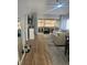 Bright living room with wood floors, neutral walls, ceiling fan, and glass doors to Florida room at 1034 Villa Ln # 18, Apopka, FL 32712