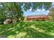 Beautiful backyard view showcasing home, boat dock, screened-in pool area, and lush greenery at 10915 Emerald Chase Dr, Orlando, FL 32836