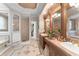 The expansive en-suite bathroom features tile floors, double sinks, a shower, and access to a walk-in closet at 10915 Emerald Chase Dr, Orlando, FL 32836