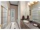 Elegant bathroom featuring granite countertop, walk-in shower, and decorative wallpaper for a luxurious feel at 10915 Emerald Chase Dr, Orlando, FL 32836