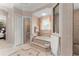 The large en-suite bathroom features tile floors, a soaking tub, a shower, and a separate water closet at 10915 Emerald Chase Dr, Orlando, FL 32836