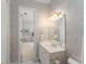 Charming bathroom with wallpaper, a vanity, a mirror, a chandelier and an attached shower at 10915 Emerald Chase Dr, Orlando, FL 32836