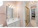 Bathroom featuring modern fixtures, tiled shower, and an adjoining bedroom at 10915 Emerald Chase Dr, Orlando, FL 32836