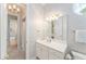 Charming bathroom featuring wallpaper, a vanity, a mirror, and an attached shower at 10915 Emerald Chase Dr, Orlando, FL 32836
