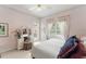 Well-lit bedroom with large windows, a vanity, and soft pink walls for a relaxing atmosphere at 10915 Emerald Chase Dr, Orlando, FL 32836