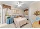 A cozy bedroom featuring white-painted walls, a queen bed, and natural light from the large windows at 10915 Emerald Chase Dr, Orlando, FL 32836