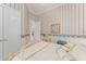 A peaceful bedroom with blue and white decor features a large bed, soft lighting, and serene ambiance at 10915 Emerald Chase Dr, Orlando, FL 32836