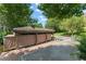 Waterfront boat dock with covered area and boat lift access in a serene, tree-lined setting at 10915 Emerald Chase Dr, Orlando, FL 32836