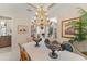 Dining room with chandelier, offering views into other parts of the home at 10915 Emerald Chase Dr, Orlando, FL 32836