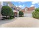 Impressive home showcasing a tile roof, circular driveway, and well-maintained landscaping at 10915 Emerald Chase Dr, Orlando, FL 32836