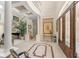 Grand foyer with high ceilings, tile floors, detailed trim and elegant staircase at 10915 Emerald Chase Dr, Orlando, FL 32836