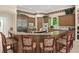 Open kitchen with granite island, stainless appliances, and counter seating at 10915 Emerald Chase Dr, Orlando, FL 32836