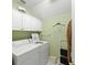 Functional laundry area featuring a modern washer and dryer with storage at 10915 Emerald Chase Dr, Orlando, FL 32836