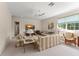 Cozy living room features neutral paint, large windows, a ceiling fan and plush seating at 10915 Emerald Chase Dr, Orlando, FL 32836