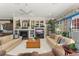 Cozy living room with built-in shelving, a fireplace, and a ceiling fan at 10915 Emerald Chase Dr, Orlando, FL 32836