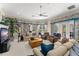 Bright living room featuring comfortable seating, a fireplace, and elegant floral accents at 10915 Emerald Chase Dr, Orlando, FL 32836