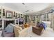 Cozy living room featuring a fireplace, built-in shelving, and large windows at 10915 Emerald Chase Dr, Orlando, FL 32836