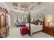 Luxurious main bedroom featuring a four-poster bed, sitting area, and coffered ceiling at 10915 Emerald Chase Dr, Orlando, FL 32836