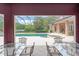 Covered patio with dining area overlooking a large swimming pool and spa, perfect for outdoor living at 10915 Emerald Chase Dr, Orlando, FL 32836